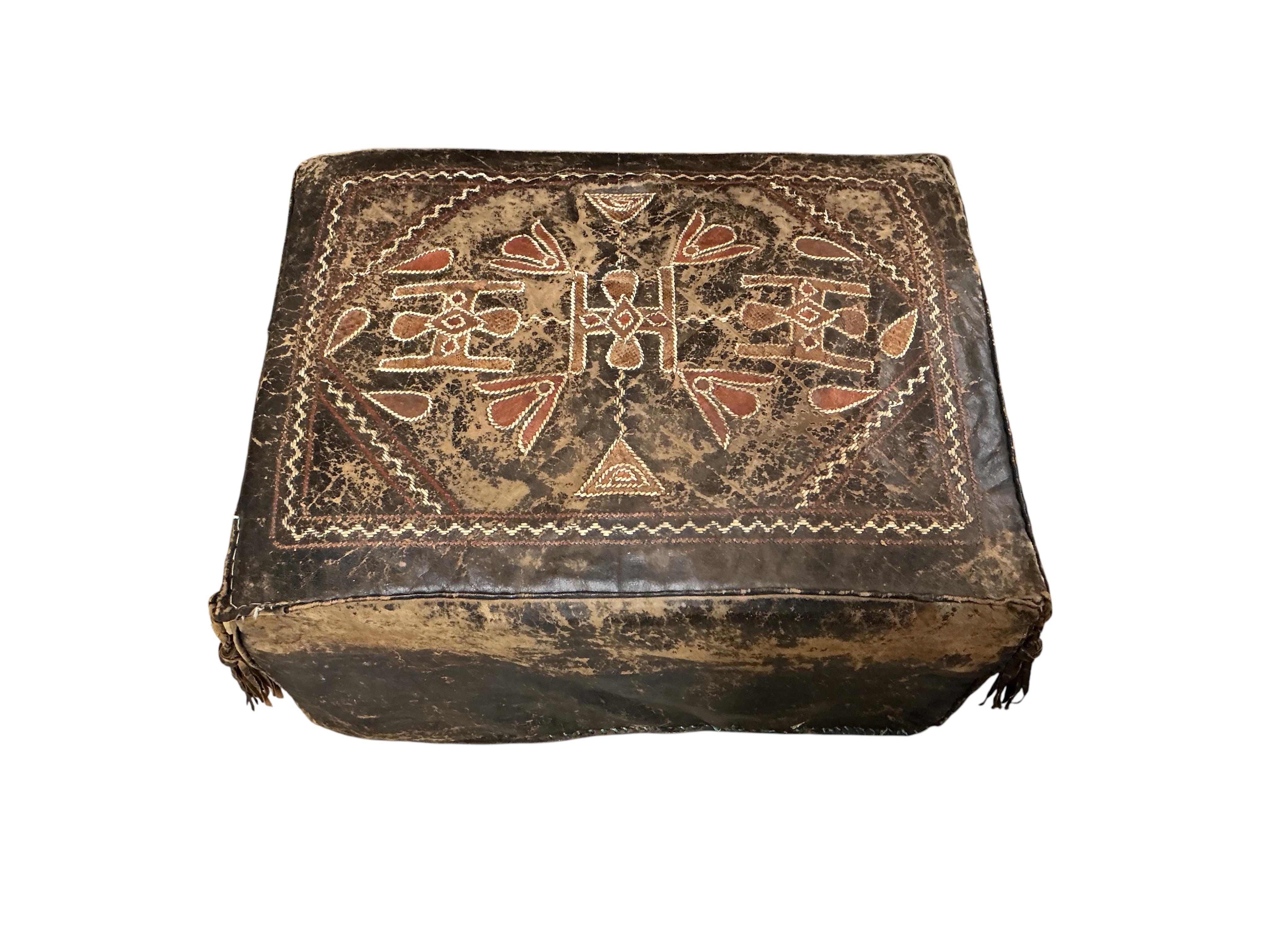 Five vintage Egyptian leather pouffe / footstools, largest diameter 60cm
